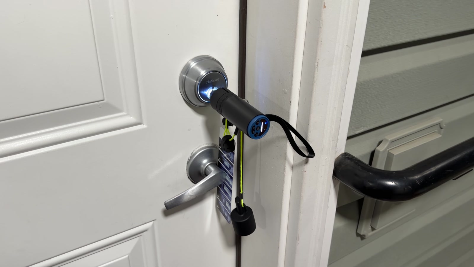 Kwikset SmartKey deadbolt being decoded with a professional locksmith decode tool during a nighttime apartment lockout in Spokane