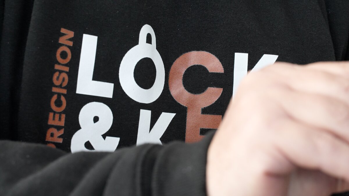 Close-up of Precision Lock & Key branded hoodie — our technicians always show up in branded apparel so you know who is at your door