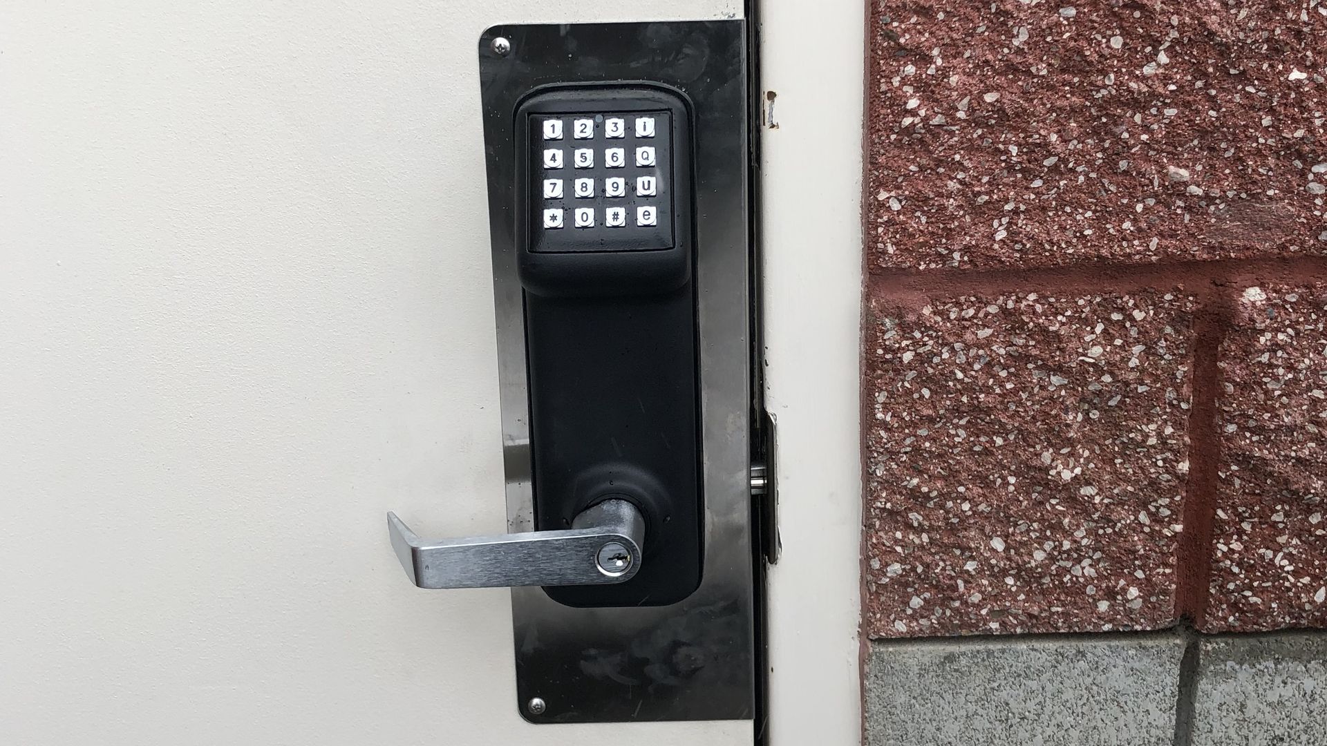 Commercial keypad entry lock installed on business door