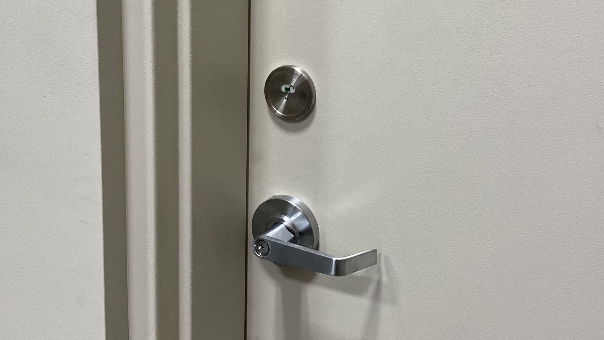 Commercial lever handle and deadbolt on office door